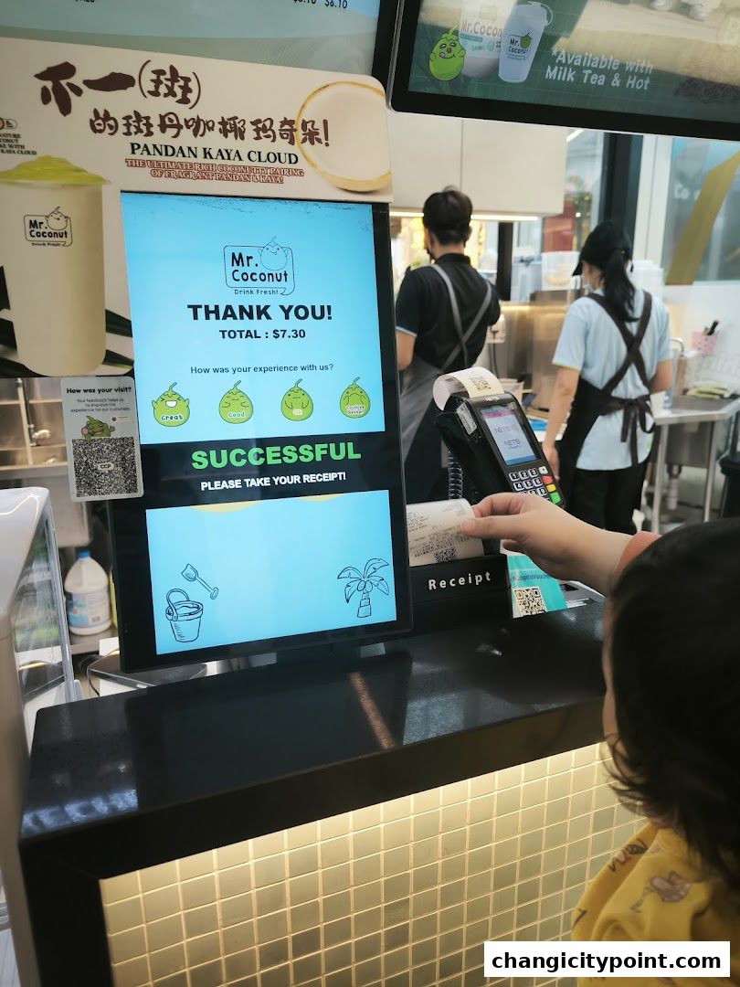 A customer receives a receipt after a successful transaction at Mr. Coconut.