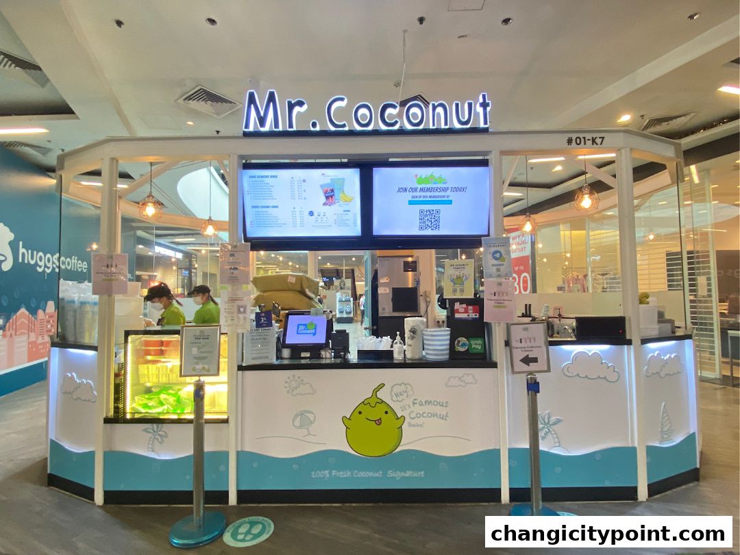 Mr. Coconut shop front with staff preparing drinks and a menu displayed.