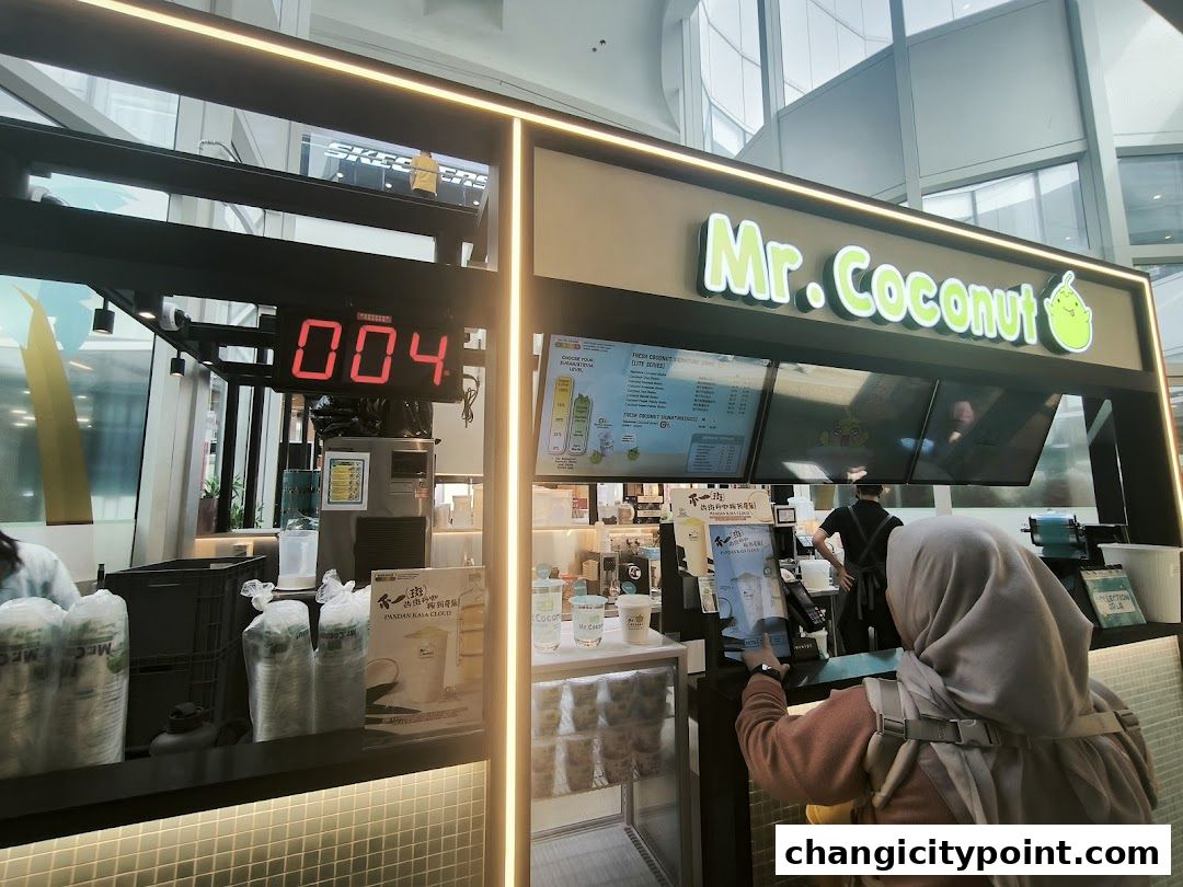 Mr. Coconut shop counter with menu boards and customers ordering drinks.