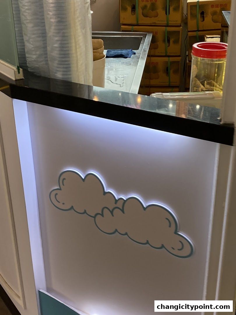 A close-up of a counter with cloud decorations and stacked boxes in the background.