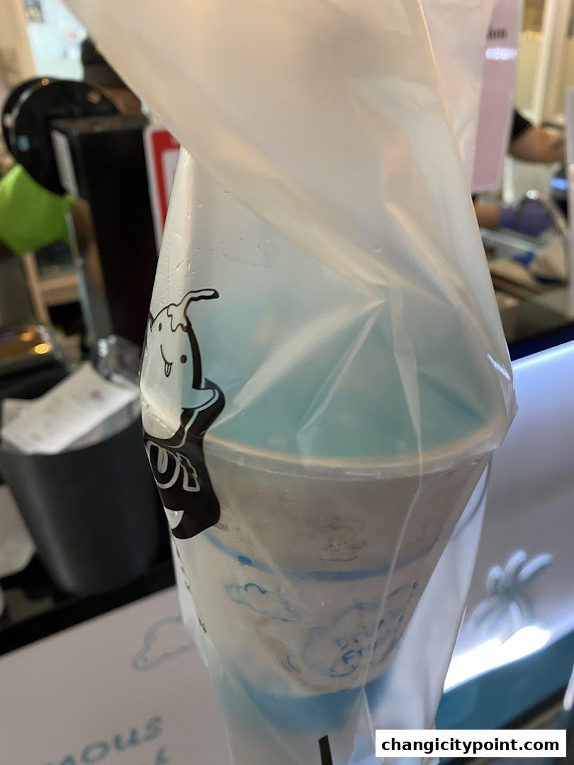 A plastic bag holding a refreshing coconut drink with a cute cartoon character.