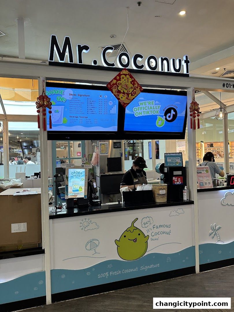 Mr. Coconut shop front with a digital menu displaying shakes and toppings.