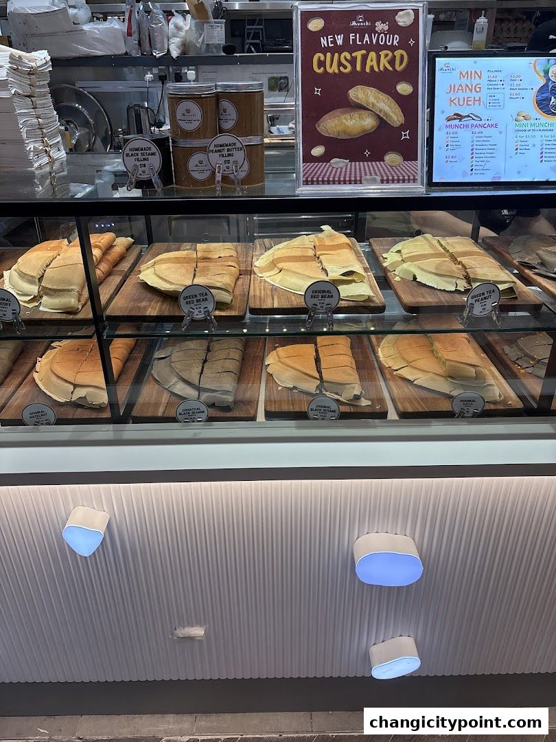 Display case filled with various types of pancakes and fillings at Munchi Pancakes.