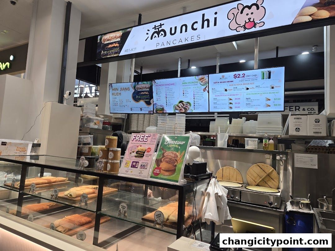 A display of pancakes and drinks at Munchi Pancakes with menu boards above.