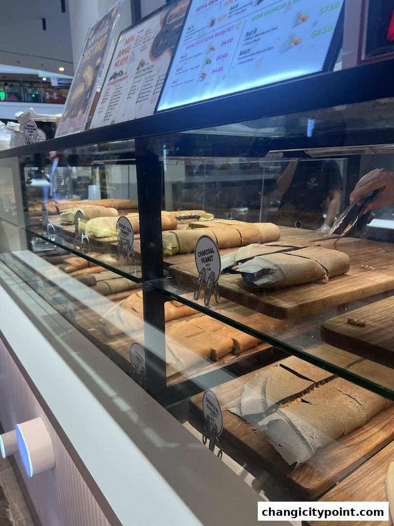 A display case filled with various types of pancakes at Munchi Pancakes.