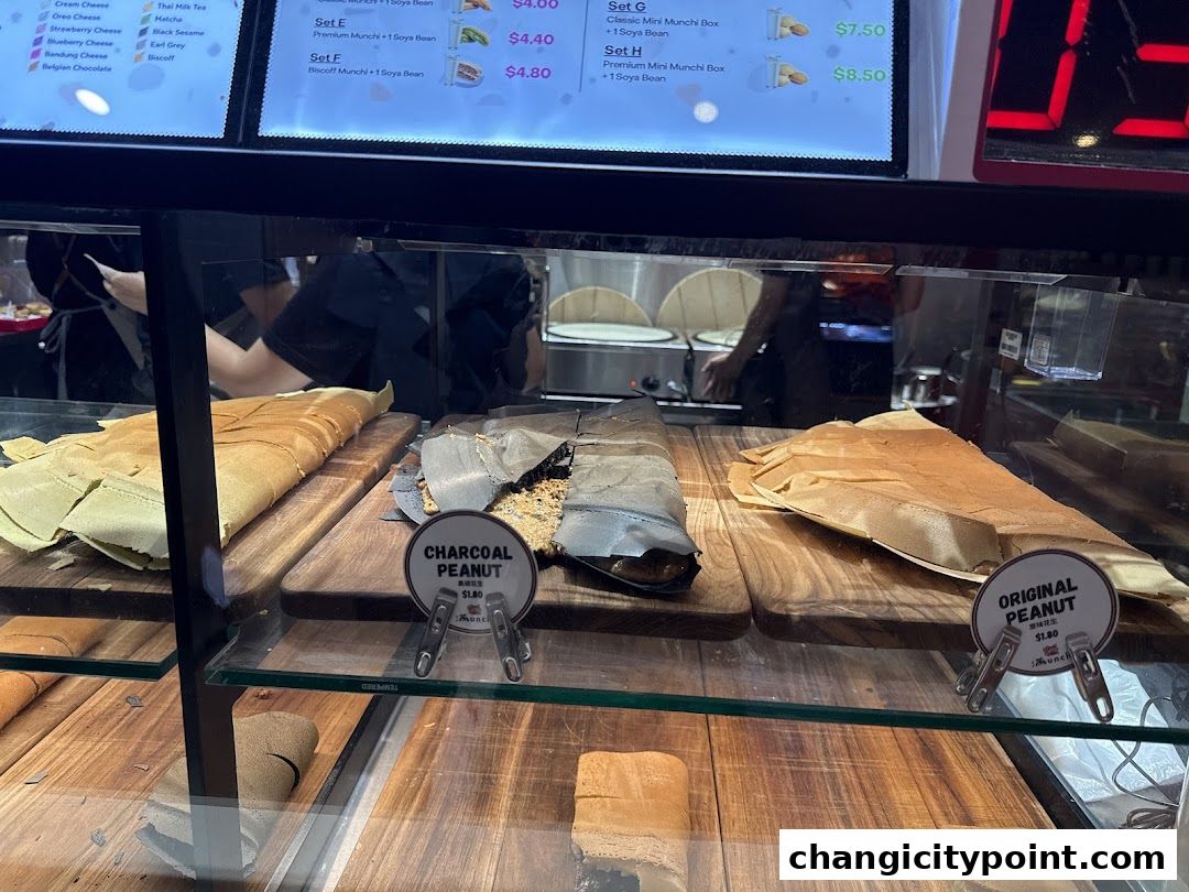 Display case with various pancake flavors and a digital menu board above.