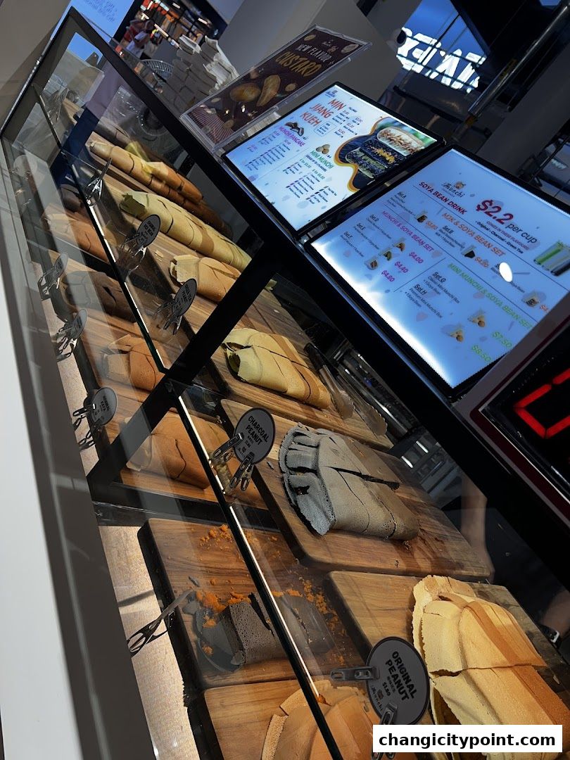 A display case filled with various flavors of pancakes and drinks offered at Munchi Pancakes.