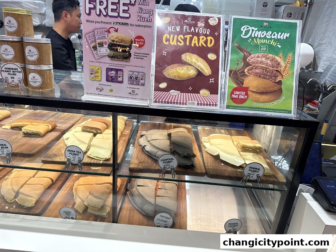 A display case filled with various flavors of pancakes and jars of peanut butter filling.