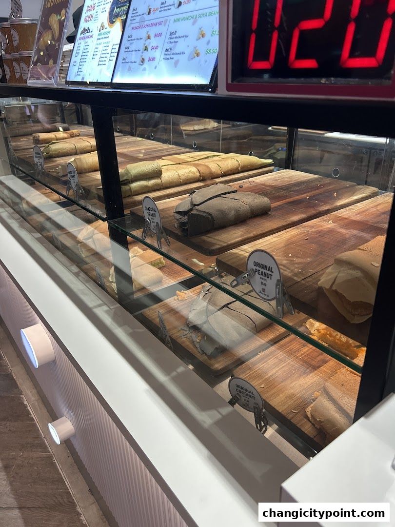 Display case filled with various types of pancakes and a digital timer.