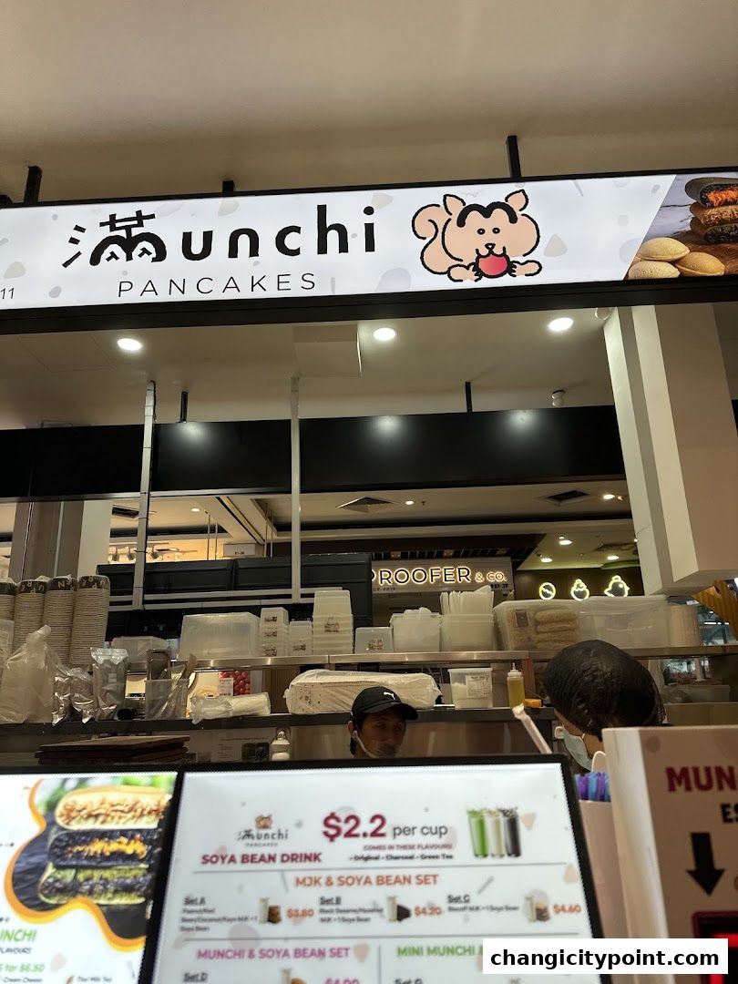 A menu board for Munchi Pancakes, showcasing soya bean drinks and pancake sets.