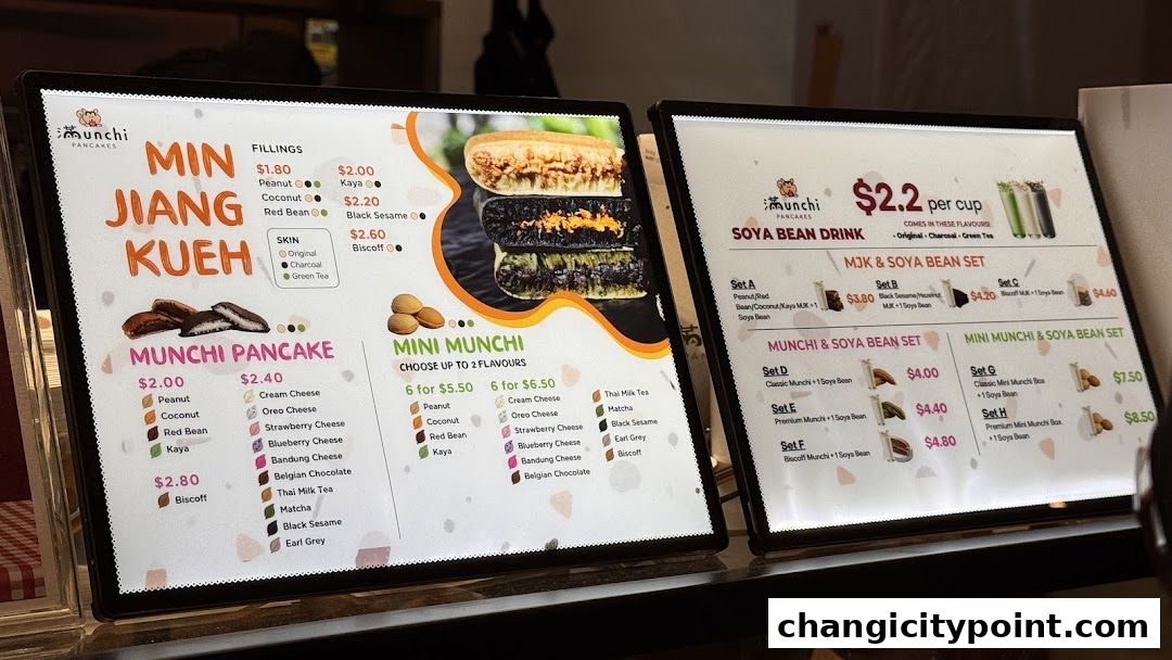 A digital menu board displaying various pancake flavors, fillings, and set meals with prices.