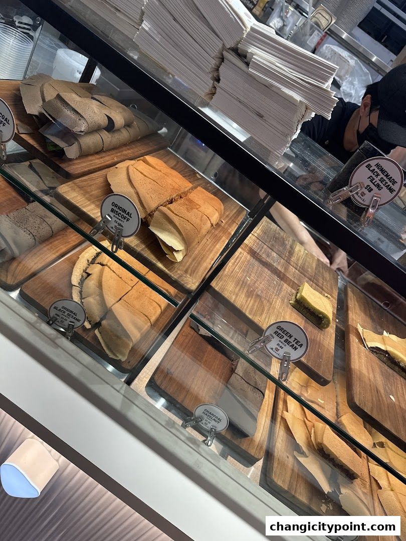 A display case filled with various flavors of pancakes and crepes at Munchi Pancakes.