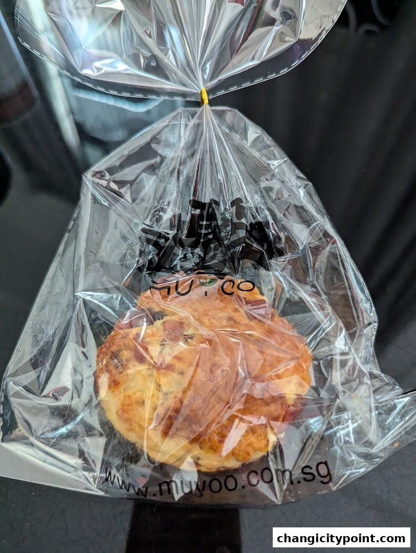 A pastry item from Muyoo Bakery, sealed in a clear plastic bag.