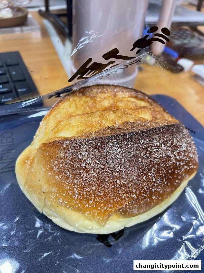 A close-up of a freshly baked pastry with sugar crystals on top.