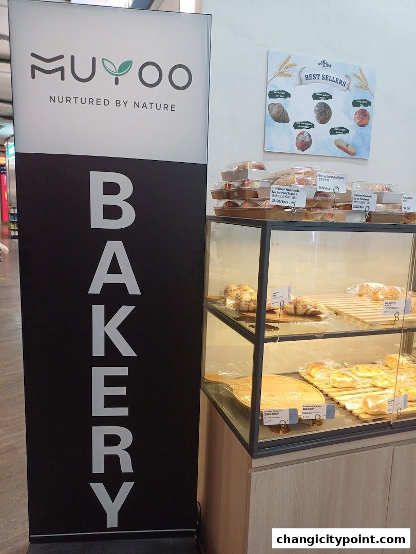 Muyoo Bakery sign and display case with various baked goods.