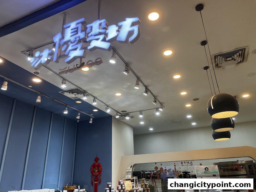 Interior view of Muyoo Bakery with illuminated signage and modern lighting.