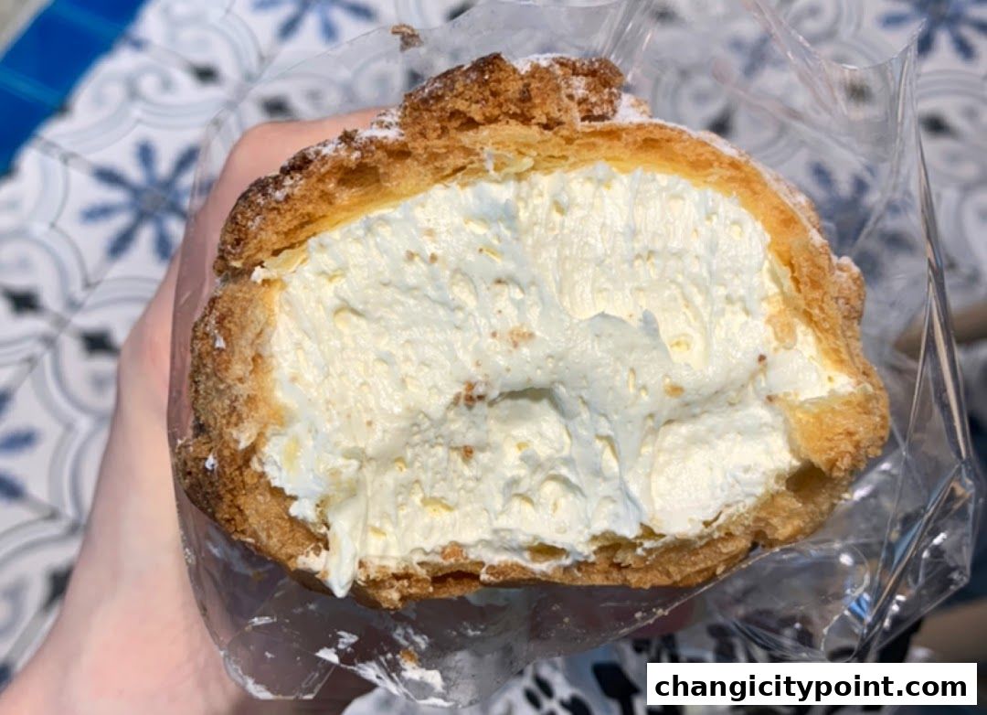 A close-up of a cream puff pastry filled with rich, creamy filling.