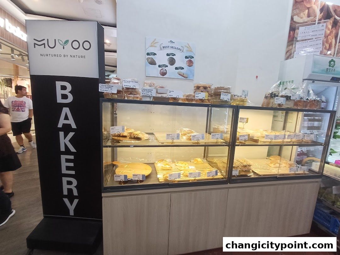 A bakery display case filled with various baked goods and a prominent 'BAKERY' sign.