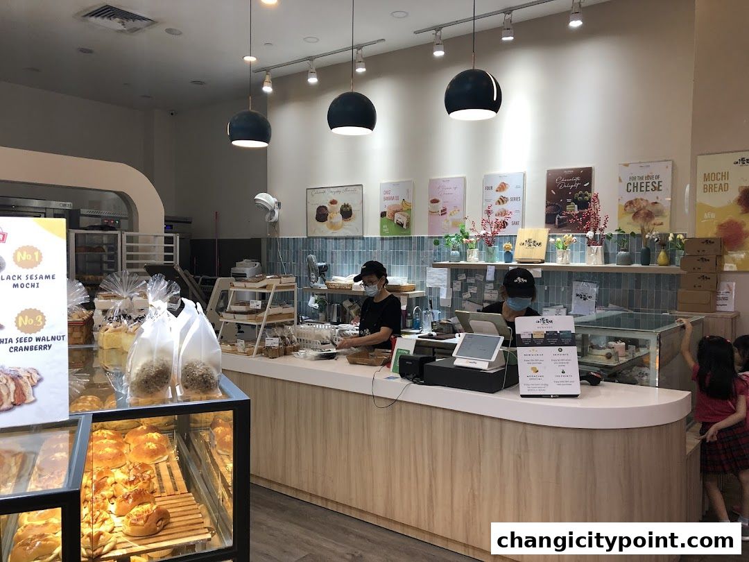 Interior view of Muyoo Bakery with display cases of pastries and a counter.