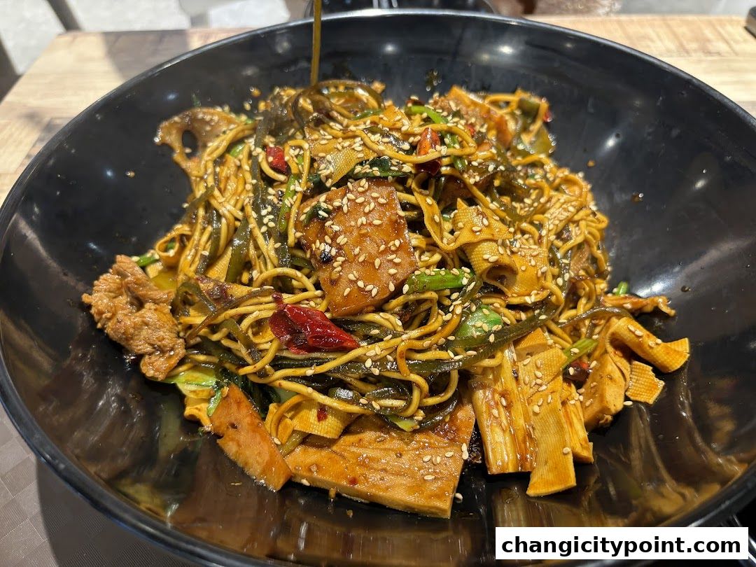 A close-up shot of a delicious bowl of noodles with various toppings and sesame seeds.