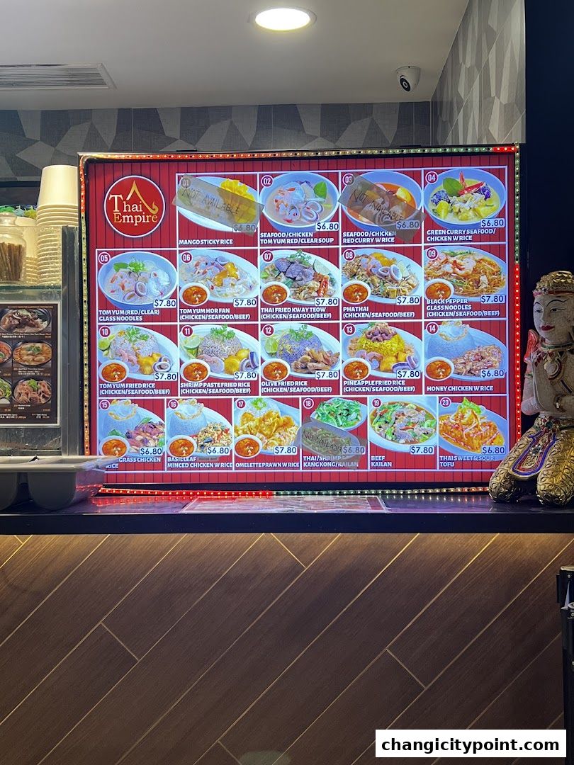 A digital menu board displaying various Thai dishes with prices and images.