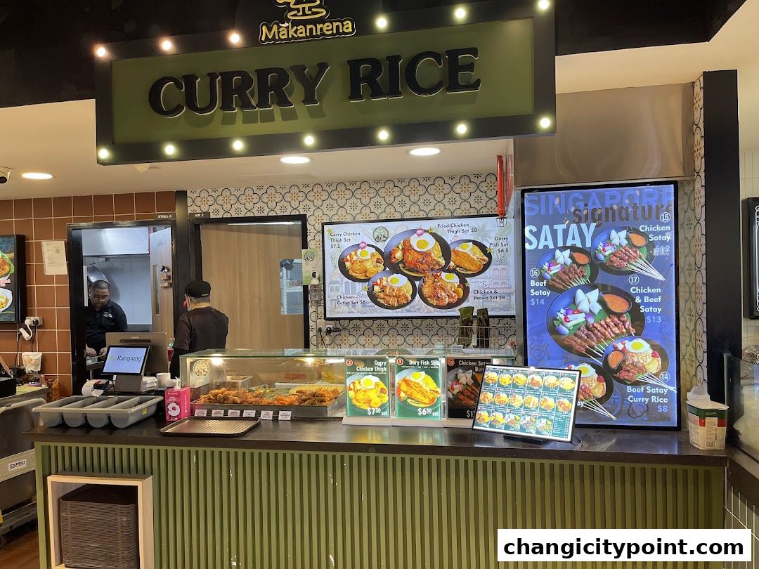 A food stall counter displaying curry rice and satay dishes with prices.