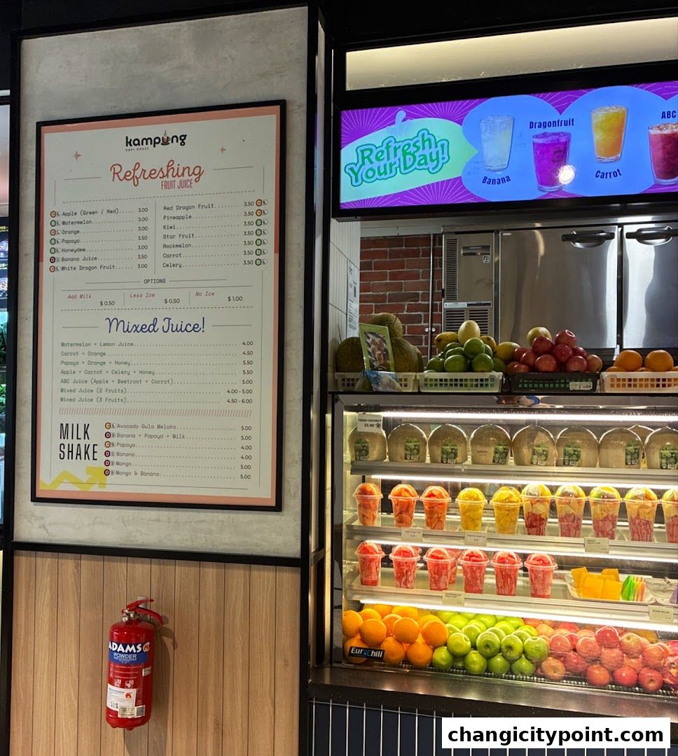 A menu board displays various fruit juices, mixed juices, and milkshakes with prices.