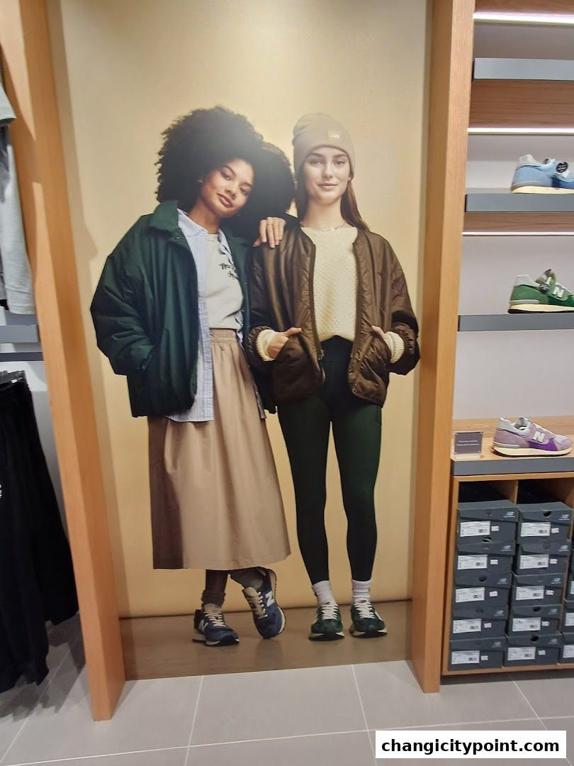 New Balance store interior featuring a large advertisement of two models wearing stylish athletic wear.