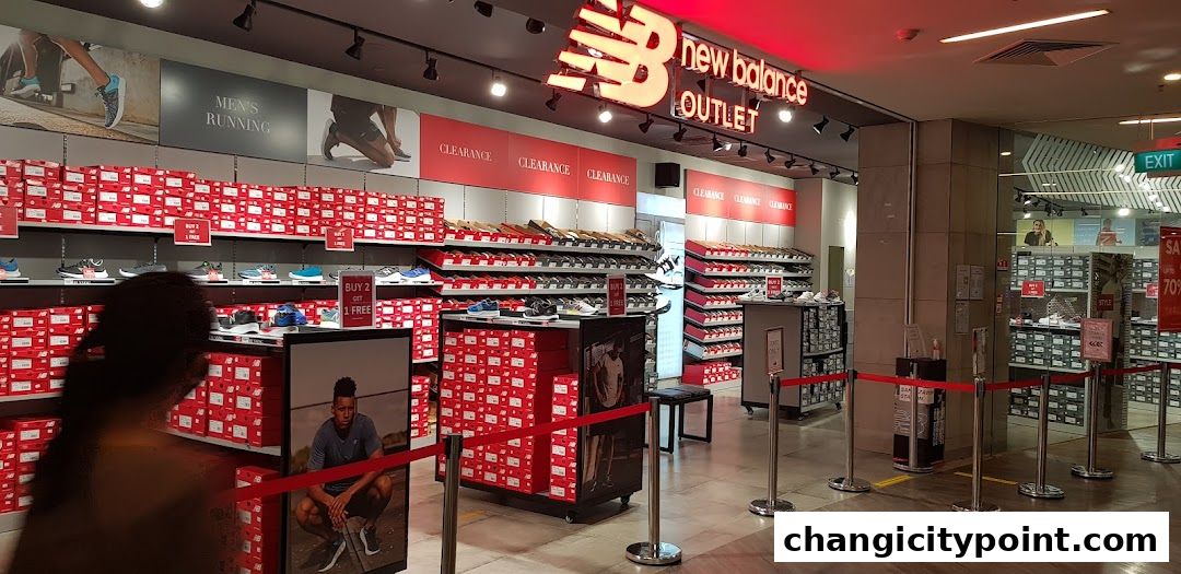 New Balance Outlet store interior with shelves full of shoe boxes and displayed footwear.