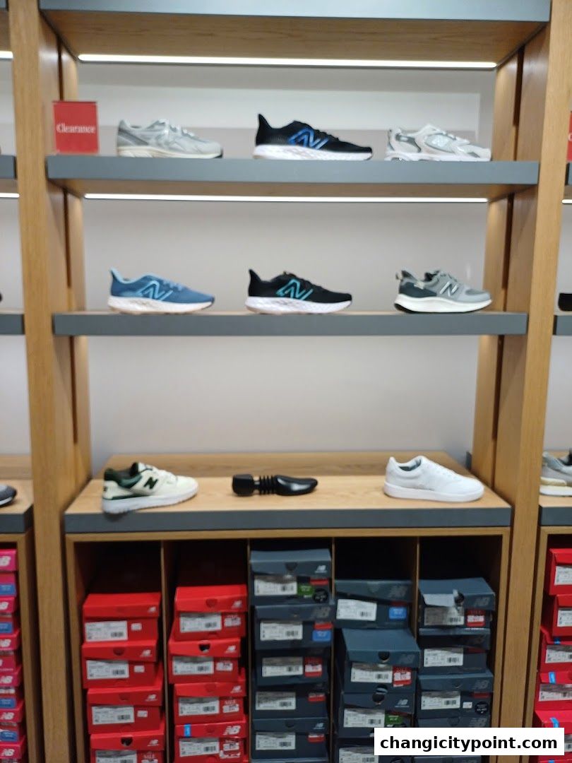 New Balance store interior showcasing shelves of athletic shoes and stacked shoe boxes.