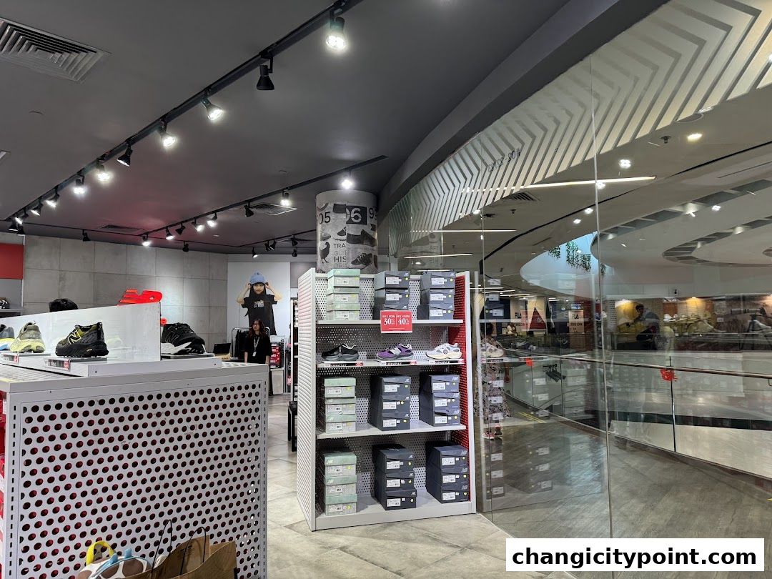 Interior view of a New Balance store showcasing shoes and merchandise.