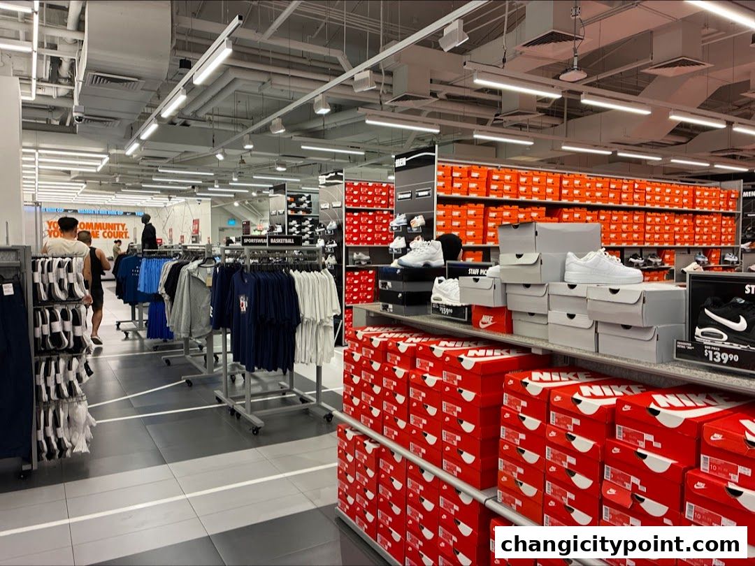 Interior view of a Nike Factory Store with shelves stocked with shoes and apparel.