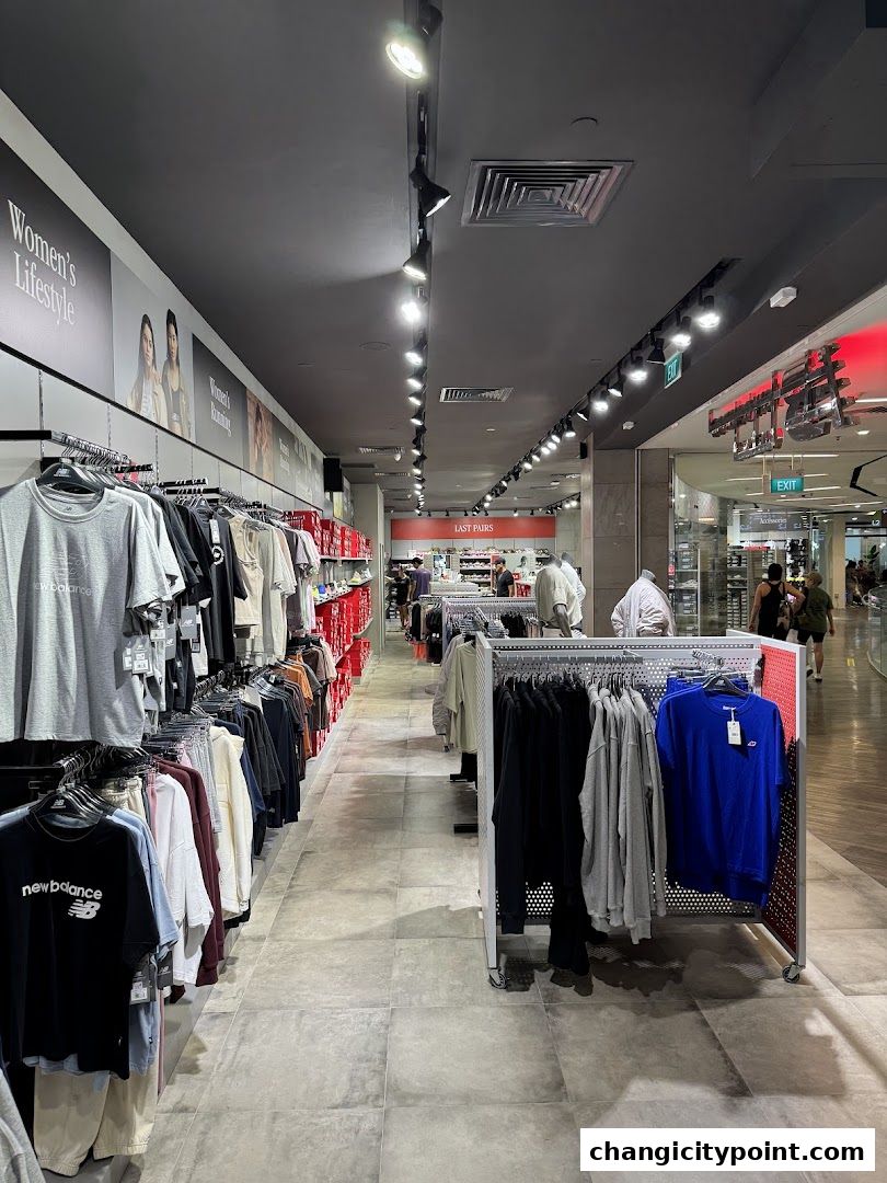 Interior view of a New Balance store showcasing apparel and footwear displays.