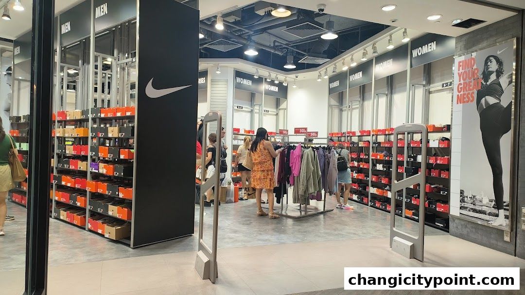 Interior view of a Nike Factory Store with shelves of shoe boxes and clothing racks.