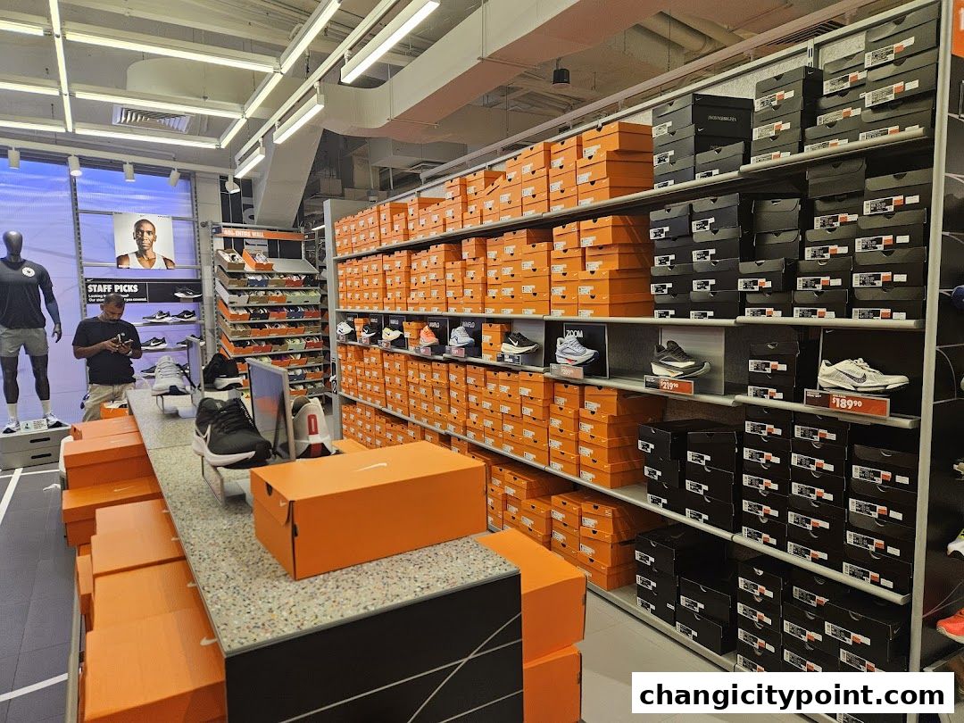 Interior view of a Nike Factory Store showcasing shelves of shoe boxes and displayed footwear.