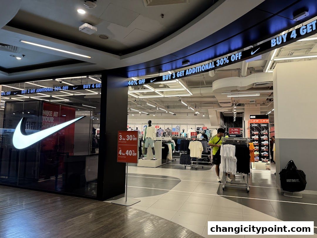 Nike Factory Store entrance with sale signs and merchandise displayed inside.