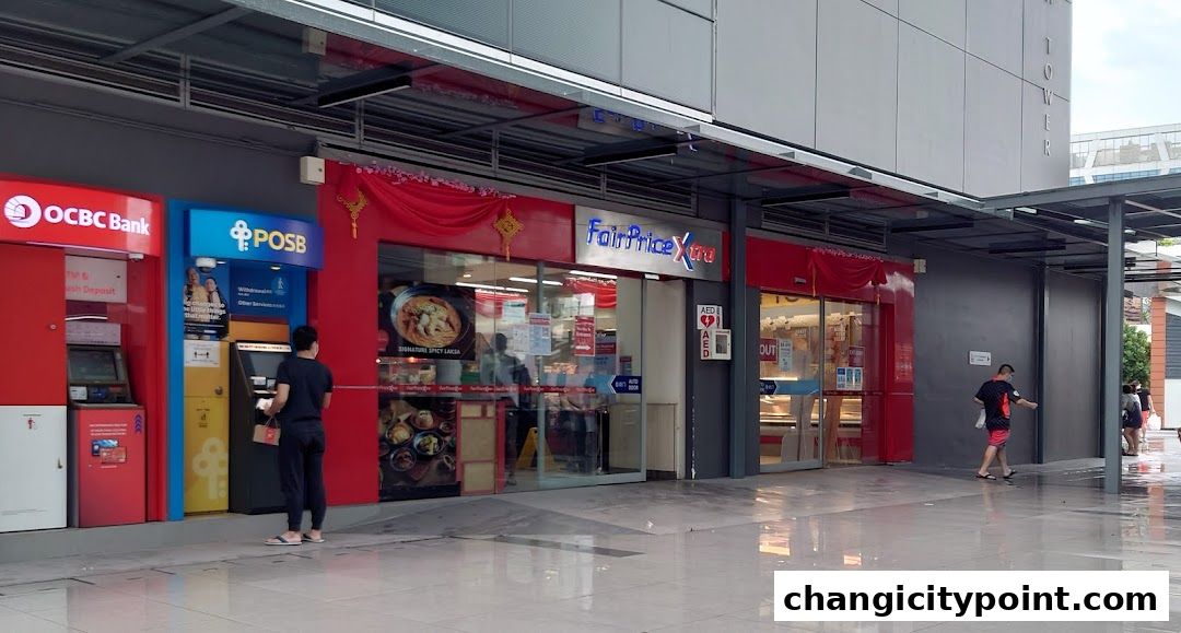 Exterior view of OCBC ATM, POSB ATM, and FairPrice Xtra supermarket.