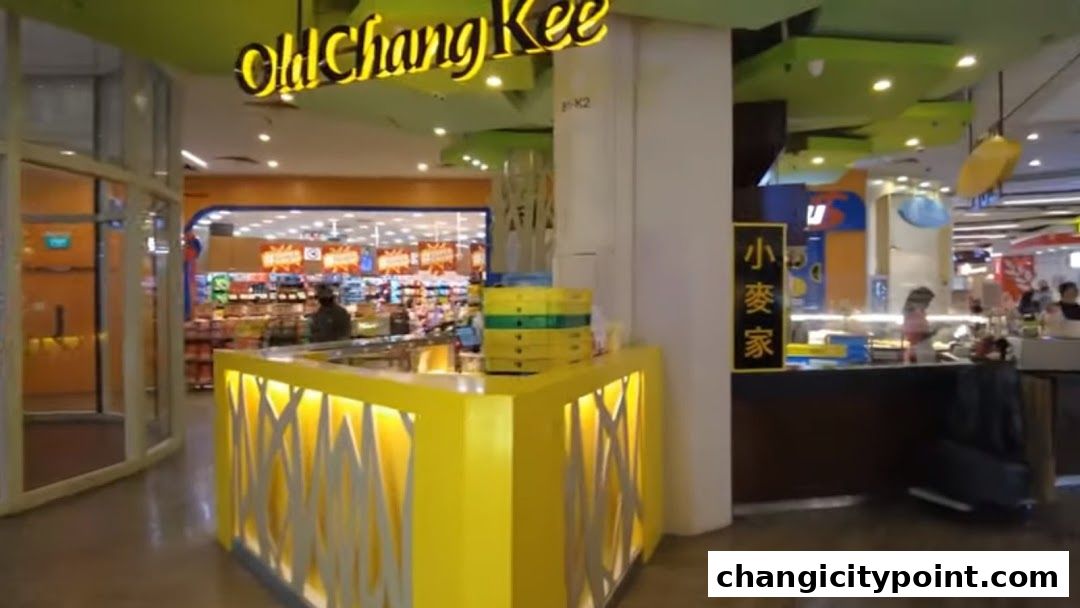 The exterior of an Old Chang Kee shop with a bright yellow counter and signage.