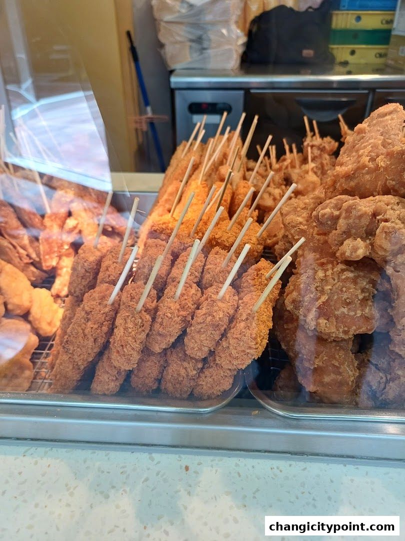 A display of freshly fried, crispy snacks on skewers at Old Chang Kee.