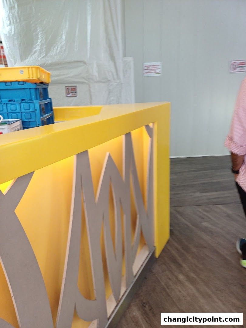 A bright yellow counter with decorative cutouts and stacked blue and yellow containers.