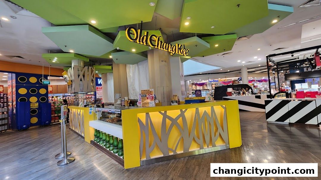 The Old Chang Kee shop front with its distinctive yellow counter and green ceiling.