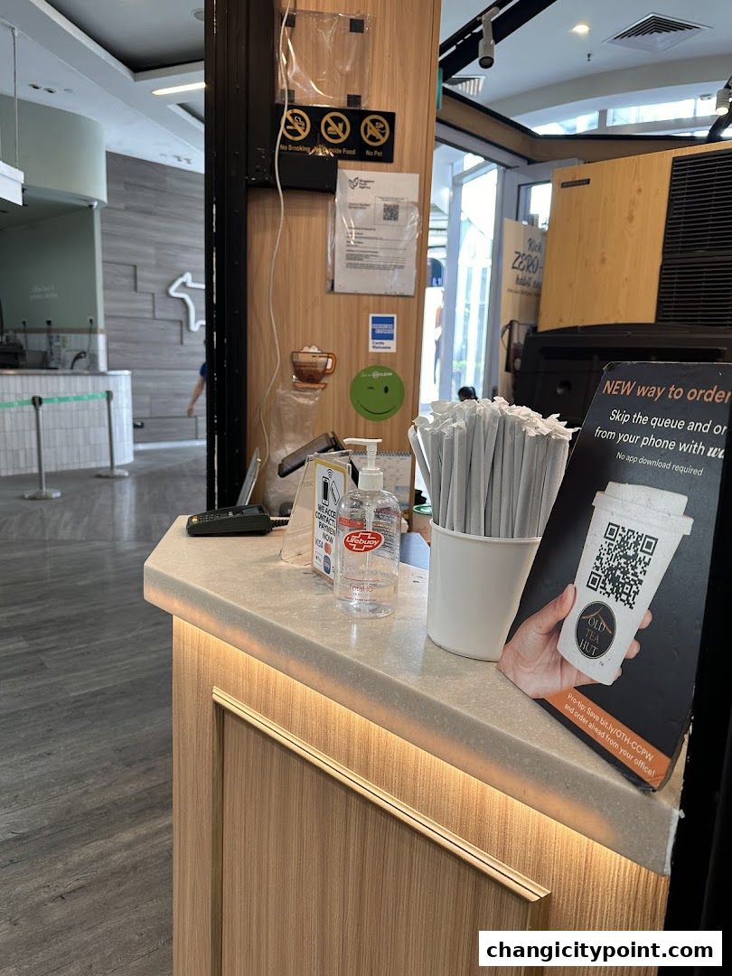 Counter at Old Tea Hut Changi City Point with ordering instructions and hand sanitizer.