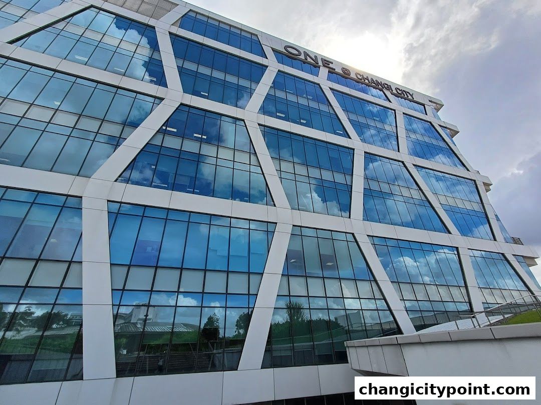 Modern building with geometric facade and reflective blue windows.