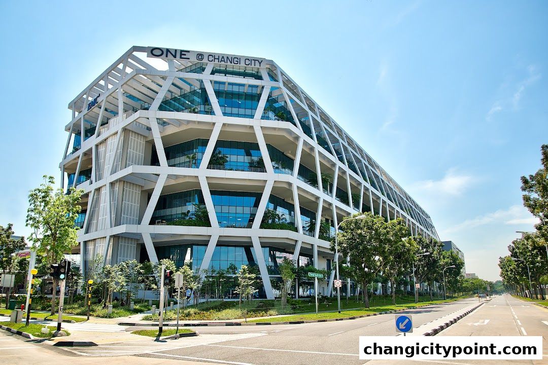 Modern architectural building with a distinctive geometric facade under a clear blue sky.