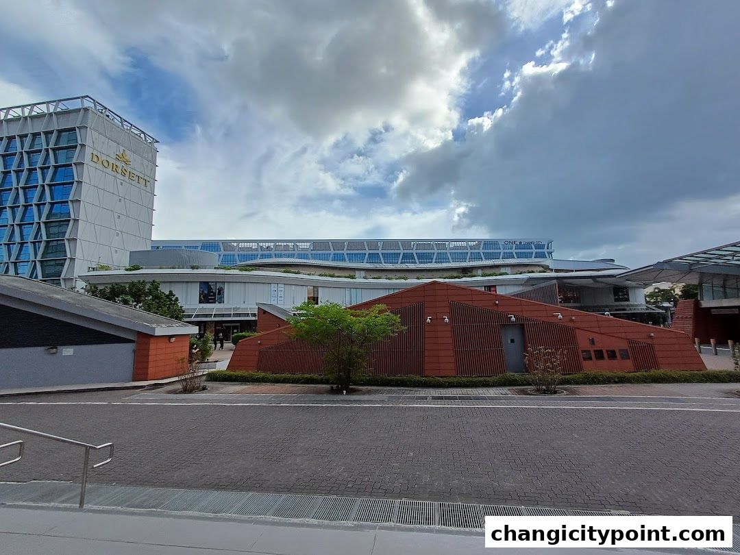 Exterior view of ONE Changi City mall with Dorsett hotel in the background.