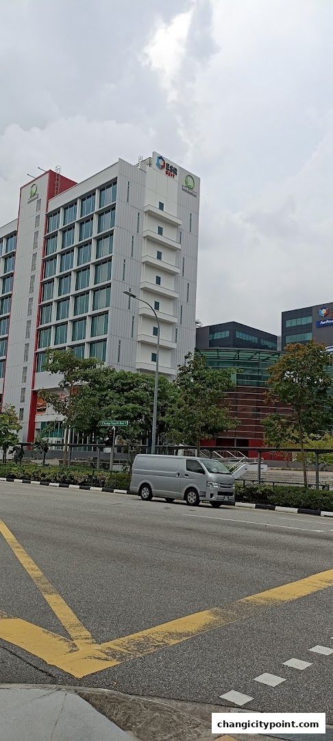 Modern buildings with glass facades and signage, including ESR REIT and FairPrice.