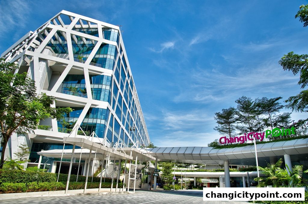 Modern architectural building with a distinctive geometric facade and lush greenery.