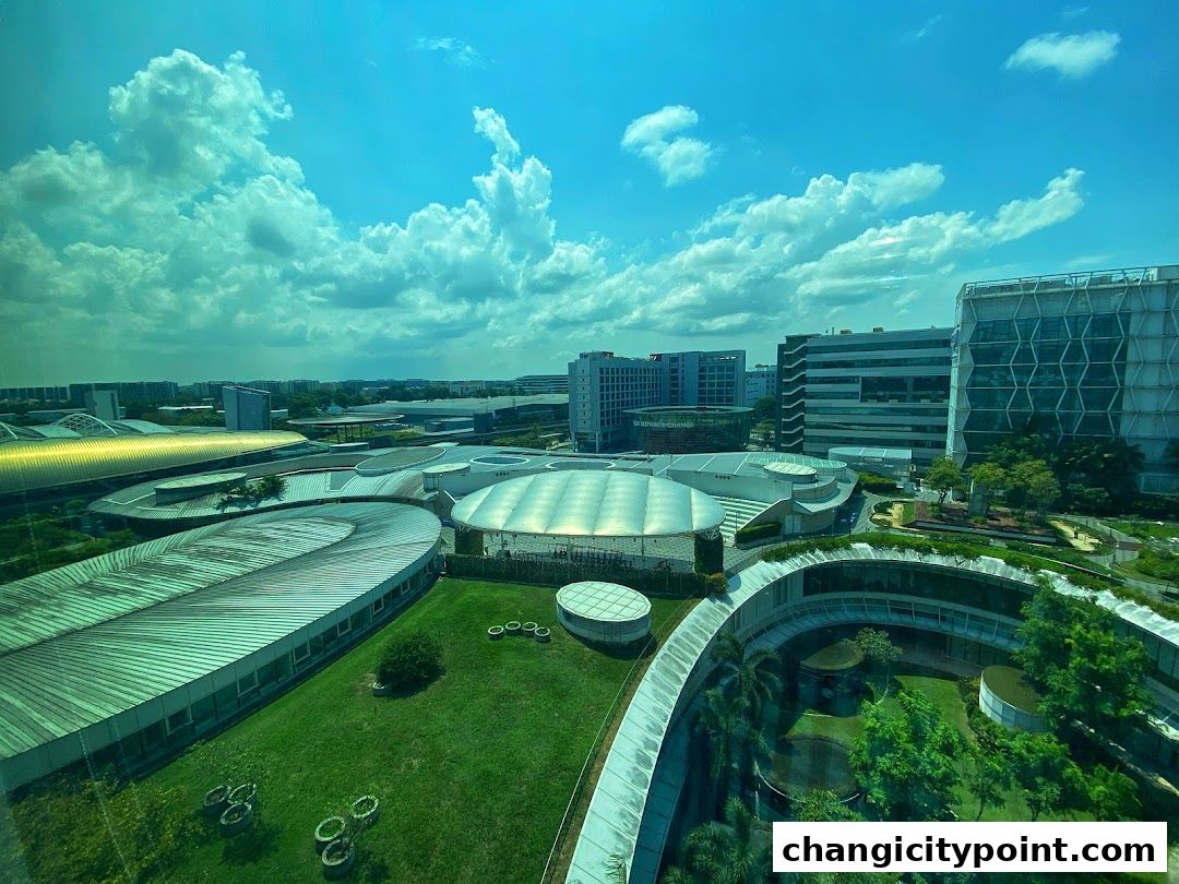 Aerial view of the ONEChangi City complex with modern architecture and green spaces.