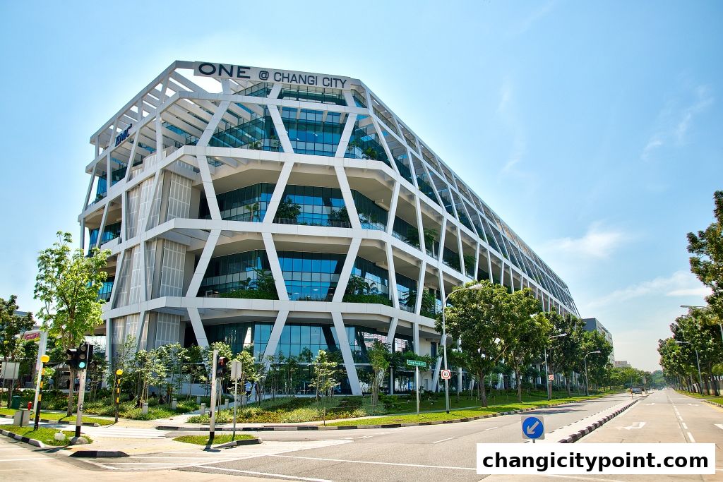 Modern architectural building with a distinctive geometric facade under a clear blue sky.
