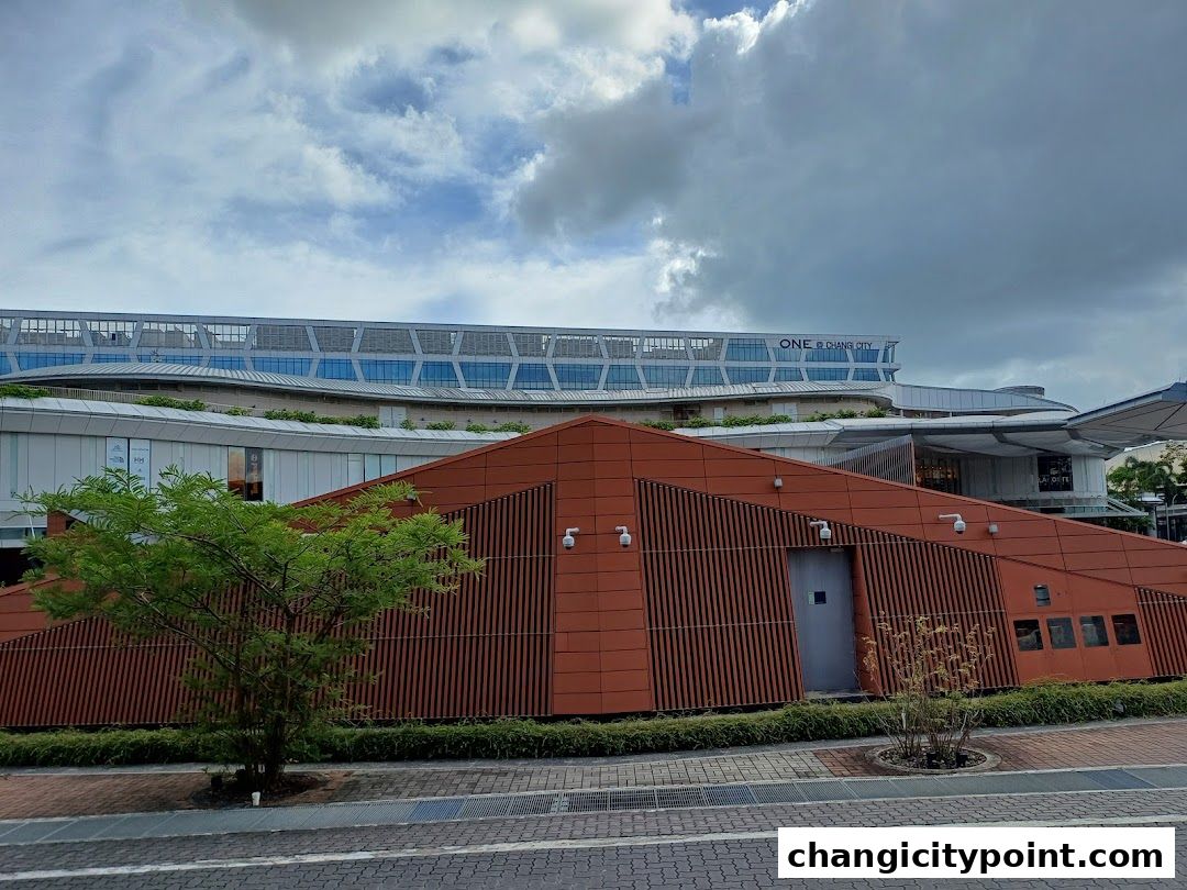 Exterior view of the ONE Changi City building with modern architecture and landscaping.